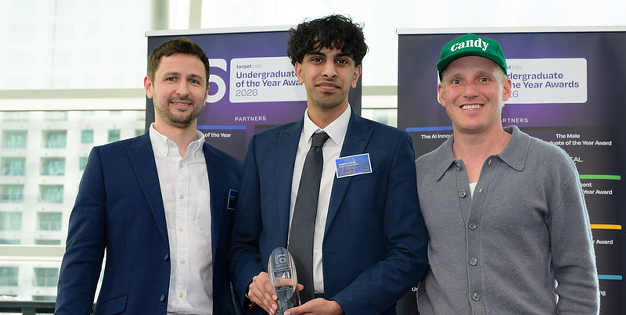 Three members of the team at the Undergraduate of the Year Awards, one holding the award trophy