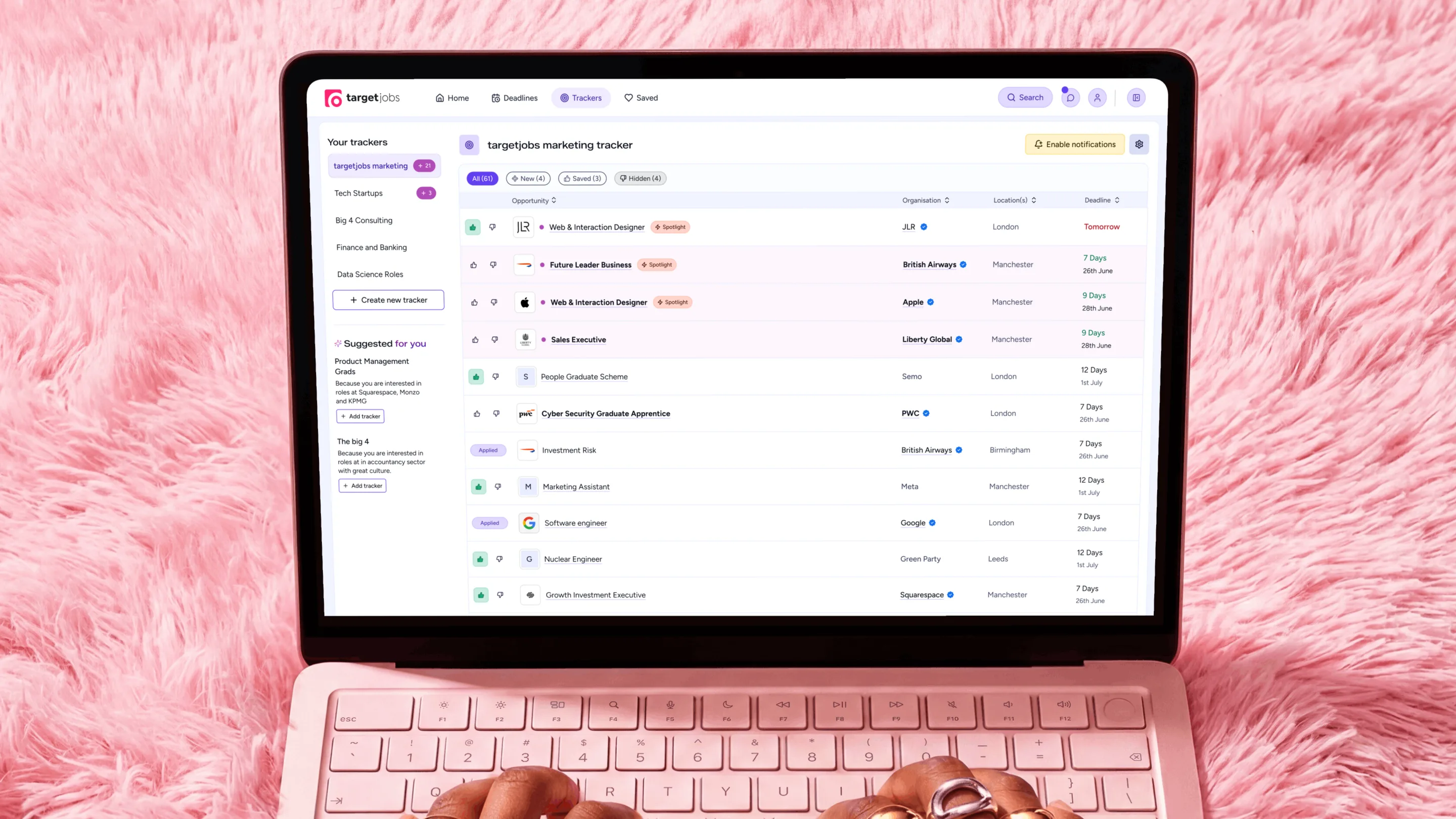 The tracker table on a laptop, a high density list of saved roles with organisation, location and deadline columns and quick favourite controls